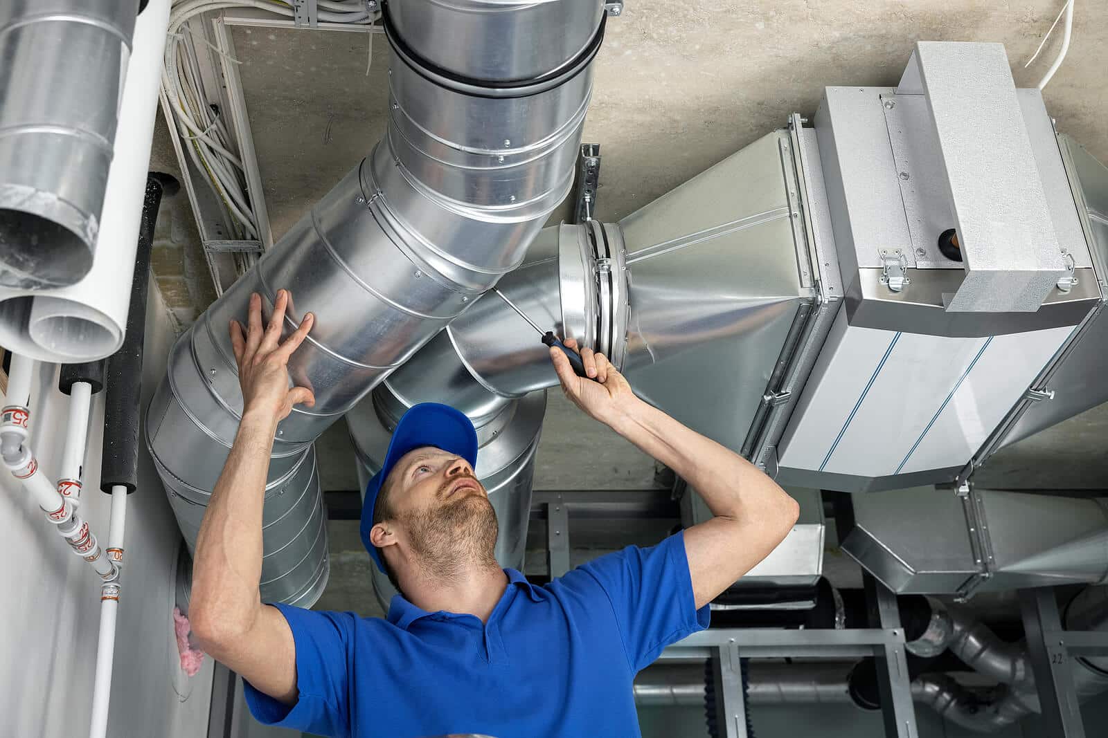 HVAC technician inspecting and repairing air ducts in Perris