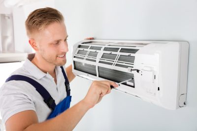 HVAC technician maintaining a ductless air conditioner in Perris