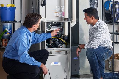 Technician evaluating a furnace for repair or replacement in Perris